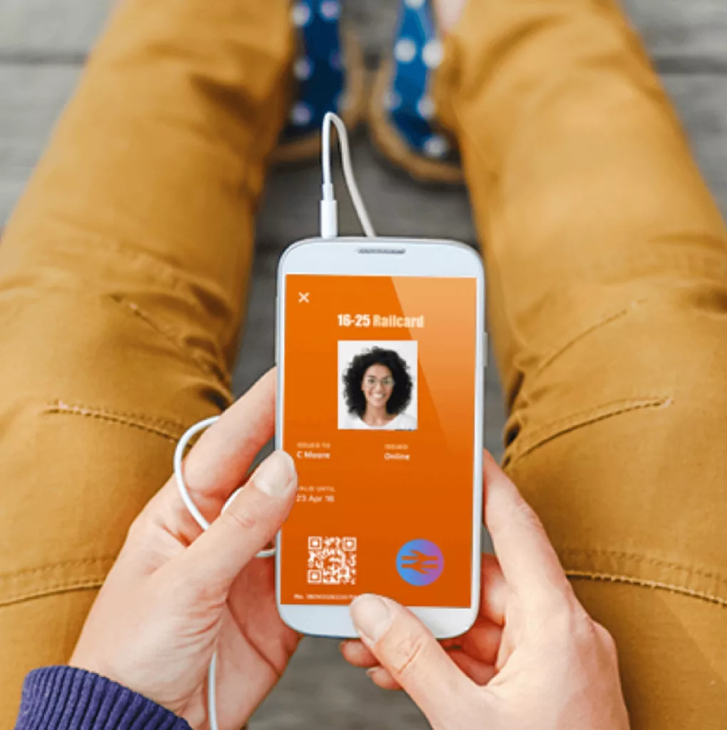 A person holding the digital 16-25 Railcard on their smartphone.