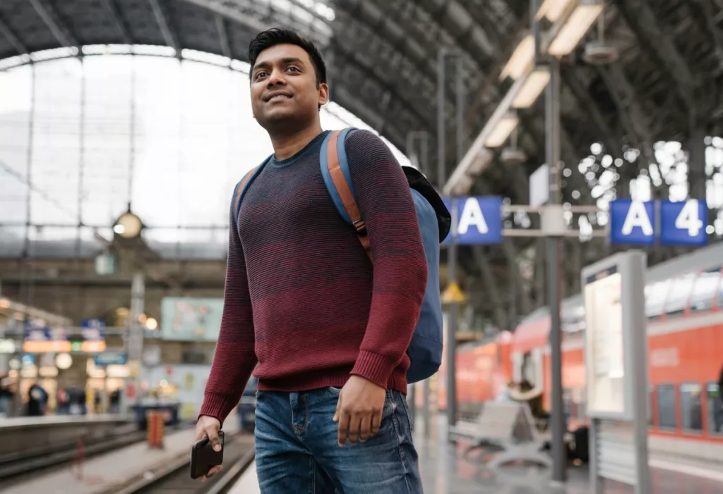 A man is waiting for the train to attend a job interview thanks to the Jobcentre Plus Travel Discount Card.