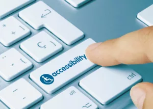 A keyboard key that reads 'accessibility', illustrating access to the Priority Services Register in the UK.